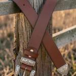 brown western leather belt with engraved buckle and decorative tip