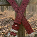 red tooled western leather belt with engraved buckle and decorative tip
