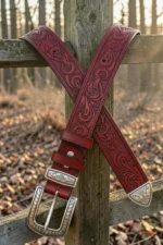 red tooled western leather belt with engraved buckle and decorative tip